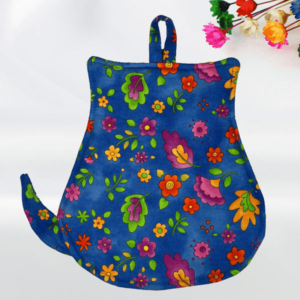 Back view of a cat-shaped potholder with a blue floral pattern, showcasing the catโs tail and simple, rounded shape. The purple accents on the ears and fabric necklace add a pop of color, making it a delightful and functional kitchen accessory.