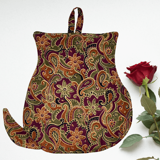 The back of the cat-shaped potholder features a soft green and brown floral cotton pattern with insulating padding. The fabric is durable, providing heat resistance and protection for your hands. The back is finished with neatly stitched edges and is designed for easy handling while baking or cooking.