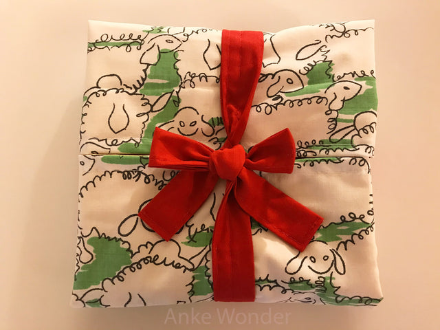 Anke Wonders eco-friendly gift wrapping option is made out of fabric and can be reused. This photo is showing the gift wrapping option with red bow.