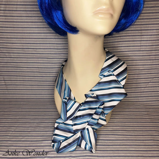 Close-up of necktie on mannequin - detailed view of blue and white striped pattern.