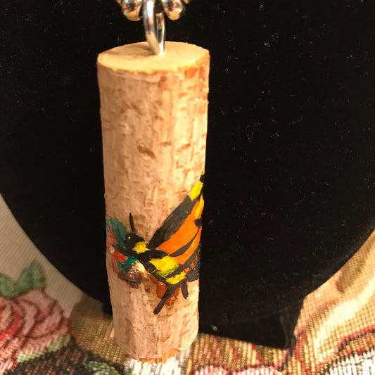 Wood with a painted bee design on a black background
