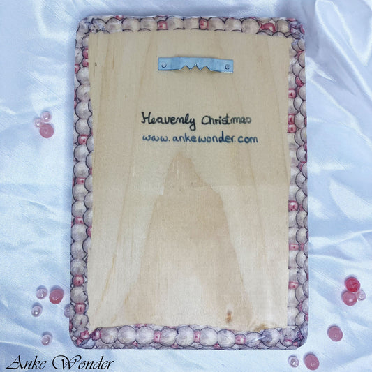 Back of handmade wooden wall art featuring sawtooth hanger for easy wall mounting – Christmas décor by Anke Wonder.