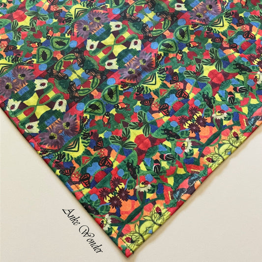 Close-up of one corner of the eco-friendly tablecloth, showing high-quality stitching and detailed floral artwork by Anke Wonder.