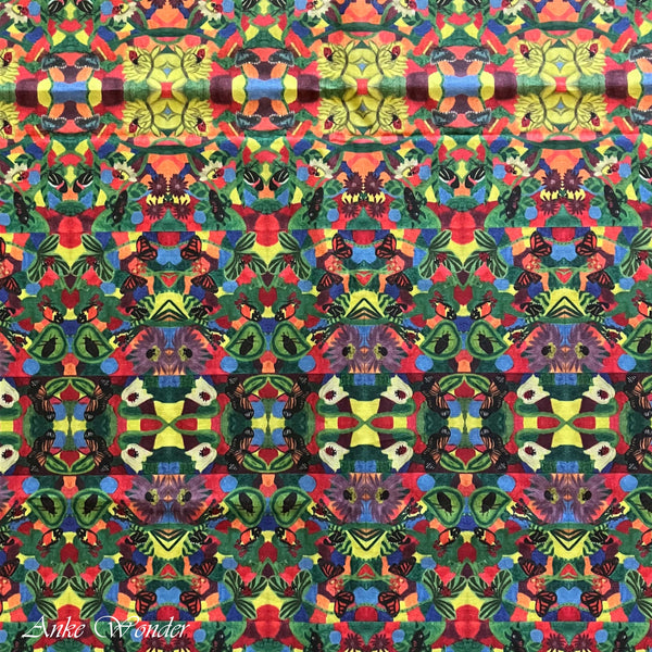 A detailed view of the colorful floral pattern with butterflies and ladybugs, digitally printed on organic cotton sateen fabric.