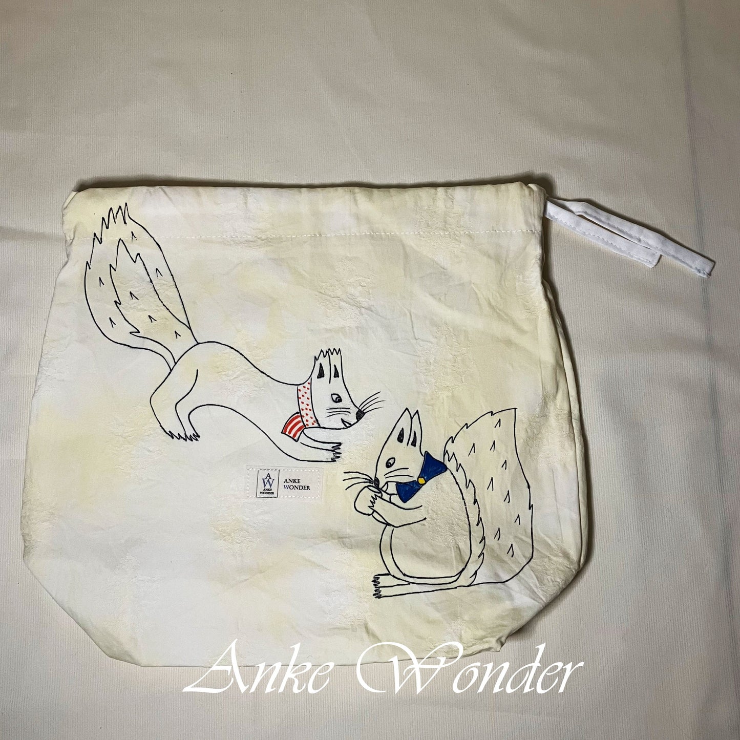 Drawstring bag with cartoon squirrel design on a plain background