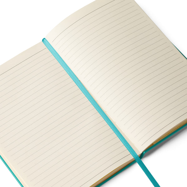 Close-up of the Lucky Paws notebook showing cream-colored lined pages with a matching green ribbon for easy marking.