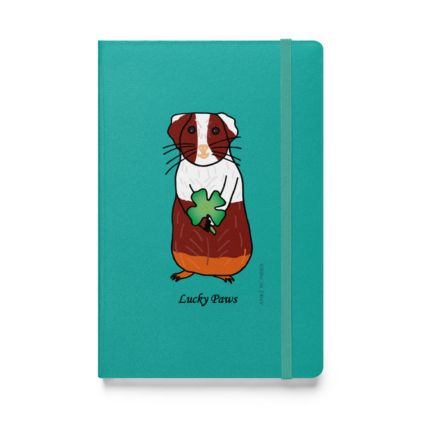 Front view of the Lucky Paws Guinea Pig Notebook featuring a cute brown and white guinea pig with a shamrock on a white background.
