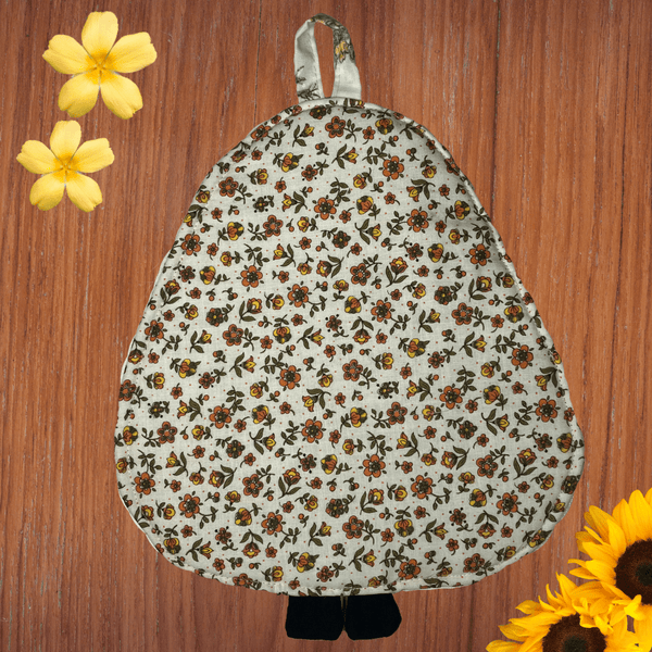 Back view of a panda-shaped potholder with a full vintage floral print in earthy colors, showing the simple and cozy design. The warm-toned floral fabric adds a touch of whimsy, making it a unique and decorative kitchen item.