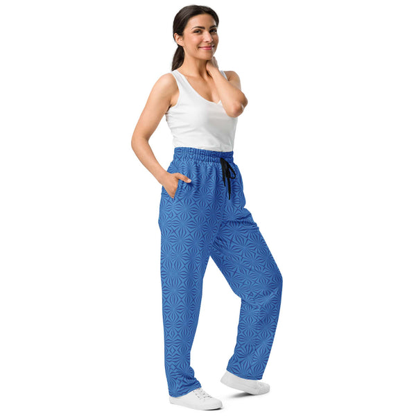 Women's wide-leg joggers with a blue geometric pattern and black drawstring shown in a side view - designed by Anke Wonder.