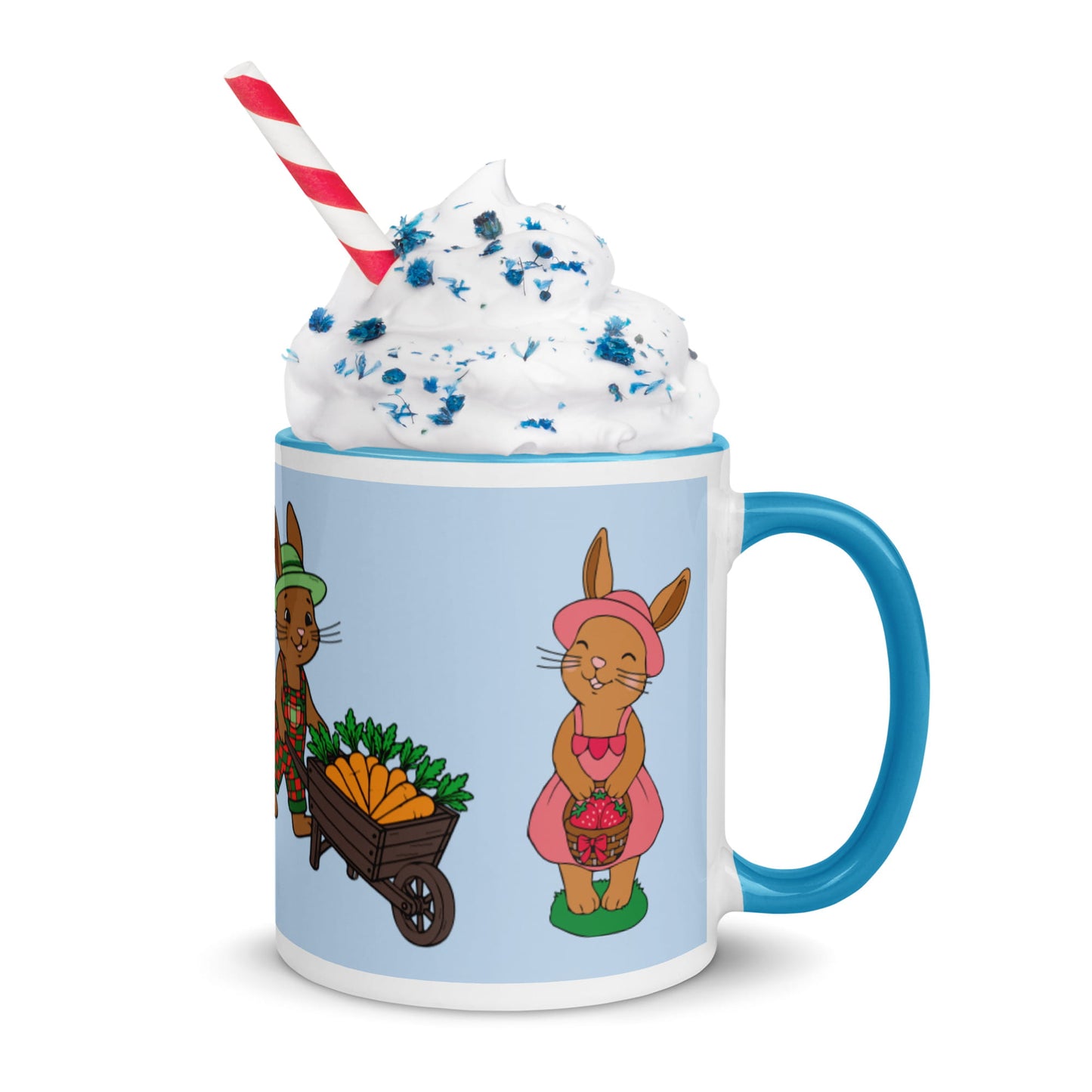 Mug with cartoon bunnies and a blue handle, featuring a whipped cream and straw decoration.