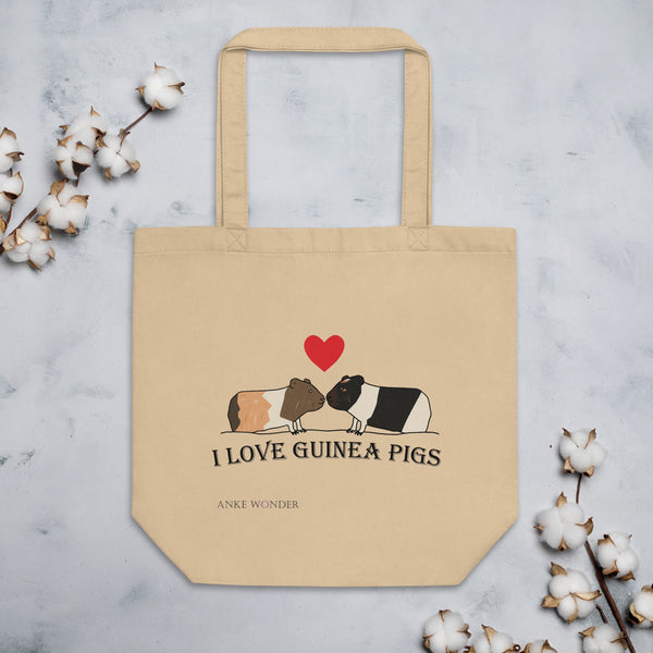 Love Guinea Pigs Tote Bag featuring a brown and black & white guinea pig snuggling under a red heart on an eco-friendly, made-to-order tote.