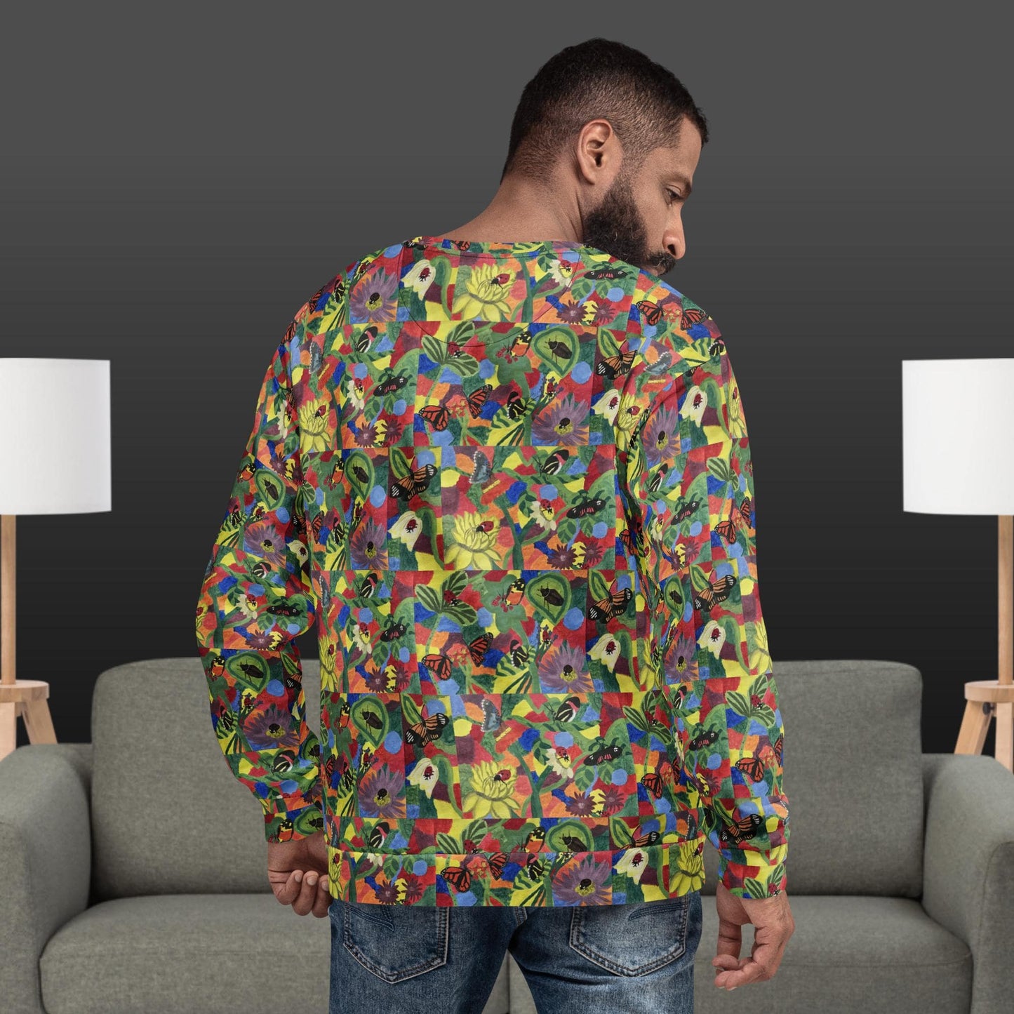 Back view of a man wearing a colorful patterned floral sweatshirt in a living room setting