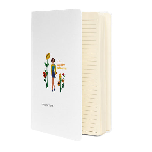 Notebook with illustration of a woman and sunflowers on the cover, white background