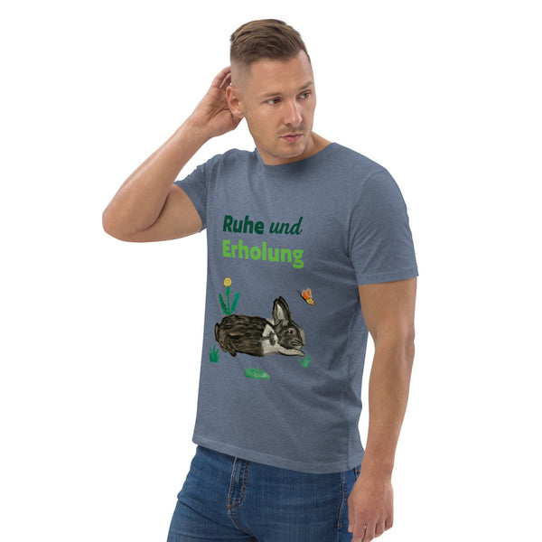 Man wearing dark heather grey organic cotton t-shirt at right angle, showing "Ruhe & Erholung" text and hand-painted rabbit, butterfly, and foliage design.