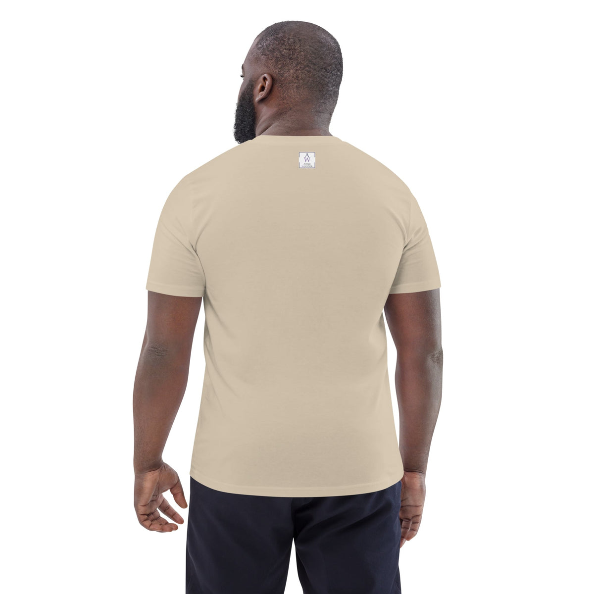 Back view of man wearing organic cotton desert dust t-shirt showing minimal Anke Wonder branding and clean design.