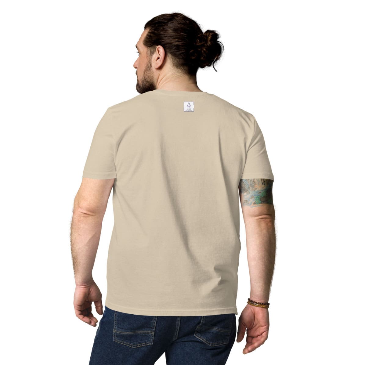 Back view of man wearing desert dust organic cotton t-shirt, showing minimalistic branding near the collar by Anke Wonder.