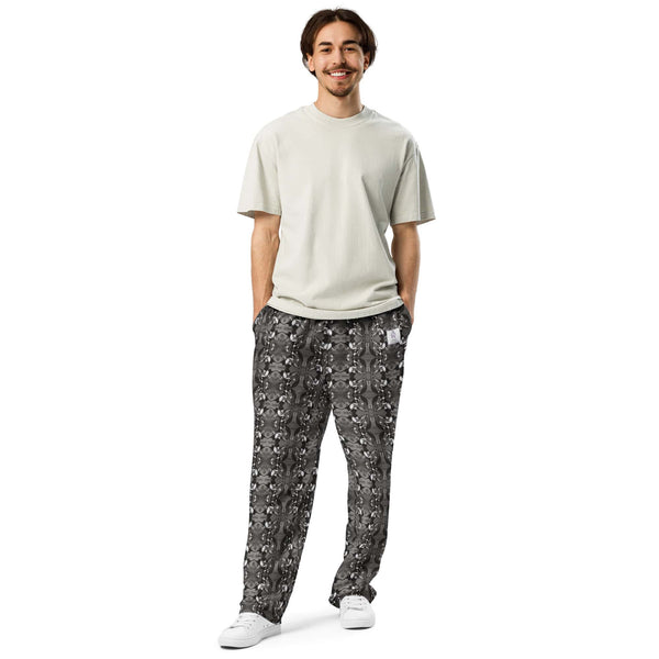 A model wearing men's wide-leg joggers, facing forward, displaying the artistic black-and-white bird design.
