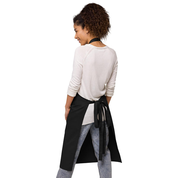 The back view of the navy apron, highlighting adjustable straps and a neat waist tie, designed by Anke Wonder.