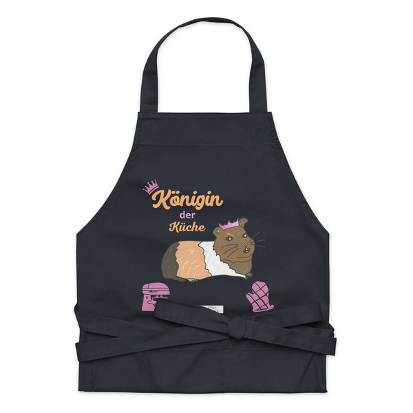 A flat-lay of the navy apron showing the detailed guinea pig design and the clear, stylish “Königin der Küche” lettering.
