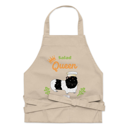 A flat-lay of the beige Salad Queen apron, showing the detailed guinea pig illustration and typography.