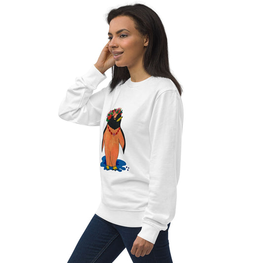 Woman wearing a white sweatshirt with a colorful penguin graphic on a white background, standing to the side.