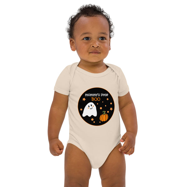 Baby boy dressed in the organic cotton bodysuit in natural color, showcasing the Halloween-themed "Mommy's Little BOO" ghost and pumpkin design. Designed by Anke Wonder.