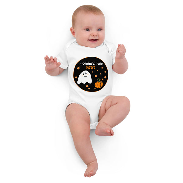 Baby girl wearing the organic cotton bodysuit in white color, highlighting the friendly ghost and pumpkin with "Mommy's Little BOO" text. Eco-friendly Halloween outfit by Anke Wonder.