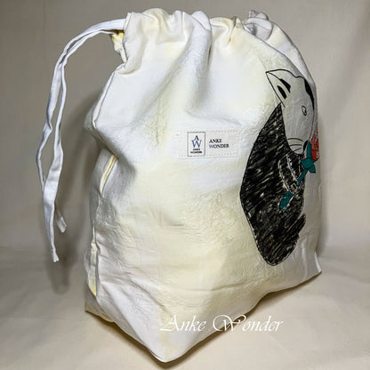 White drawstring bag with black bunny design and 'Anke Wonder' branding on a light gray background