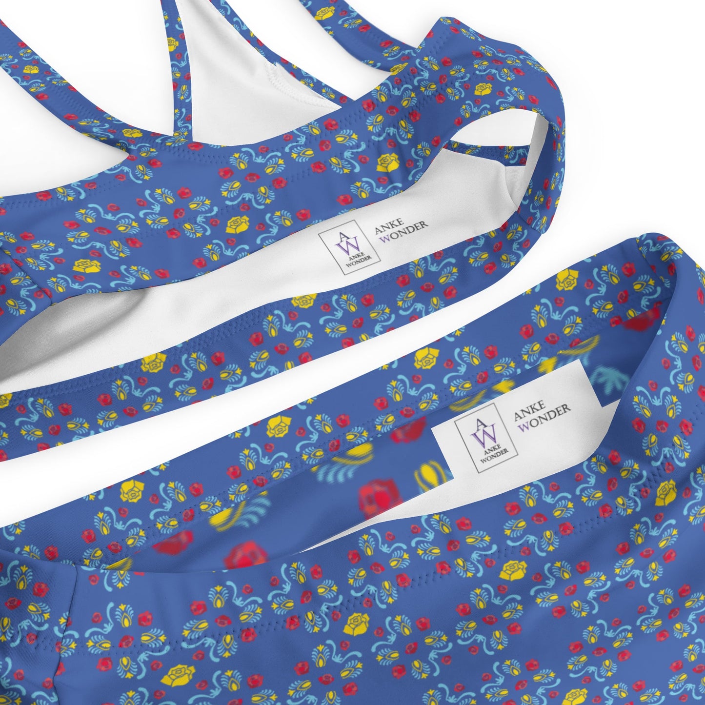 A flat-lay image of the blue rose print bikini with a close-up of the Anke Wonder label.