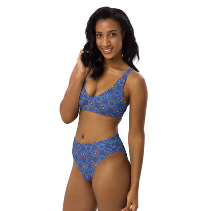 A side-angled view of a woman wearing a sustainable high-waisted bikini with a blue rose pattern, highlighting the soft, double-layered fabric.