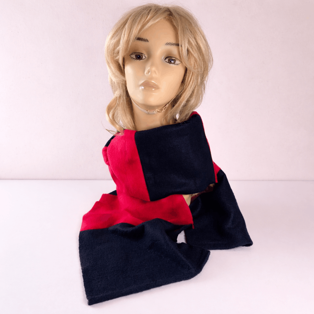Mannequin wearing a navy and red scarf on a white background