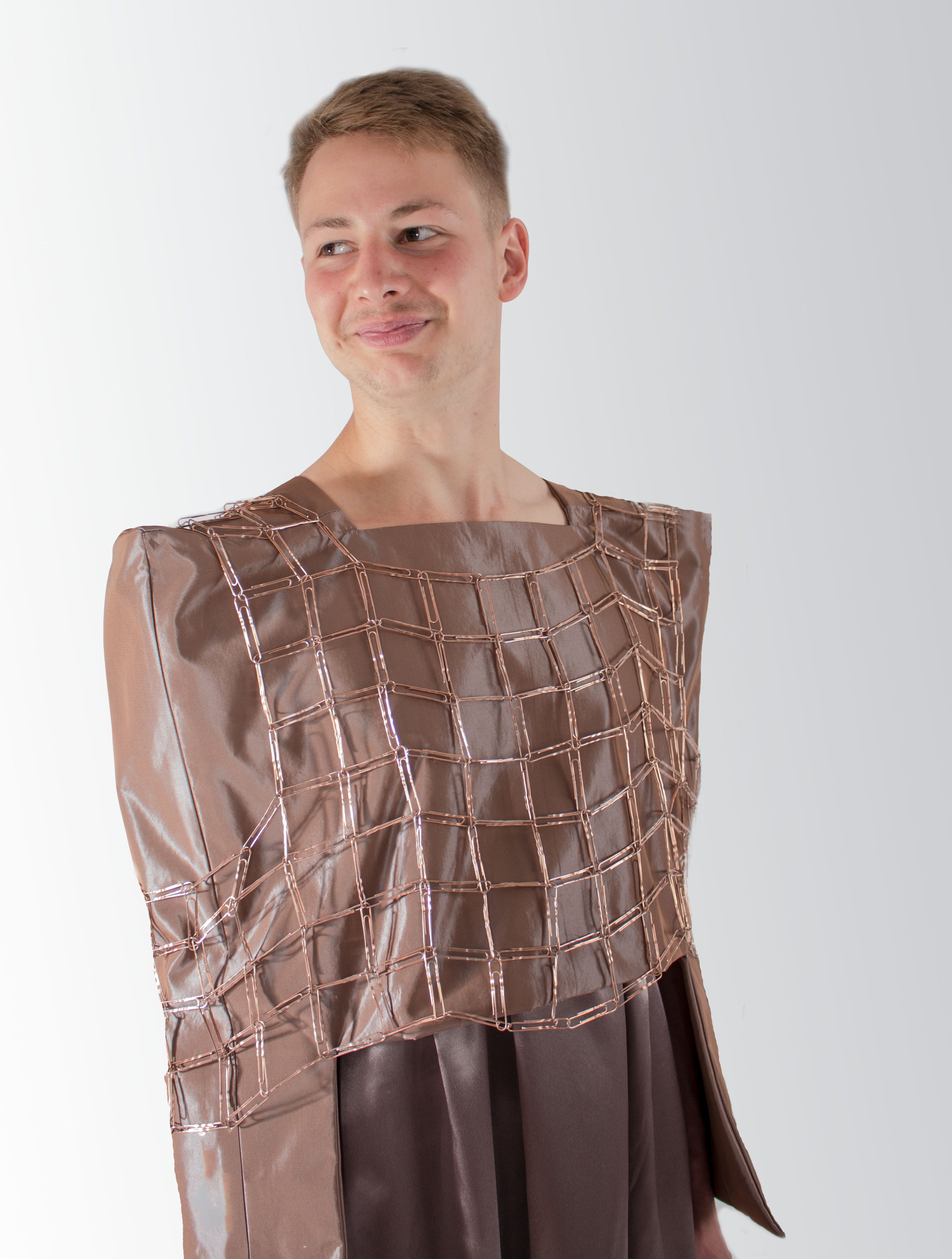 Person wearing a brown dress with a unique design on a white background
