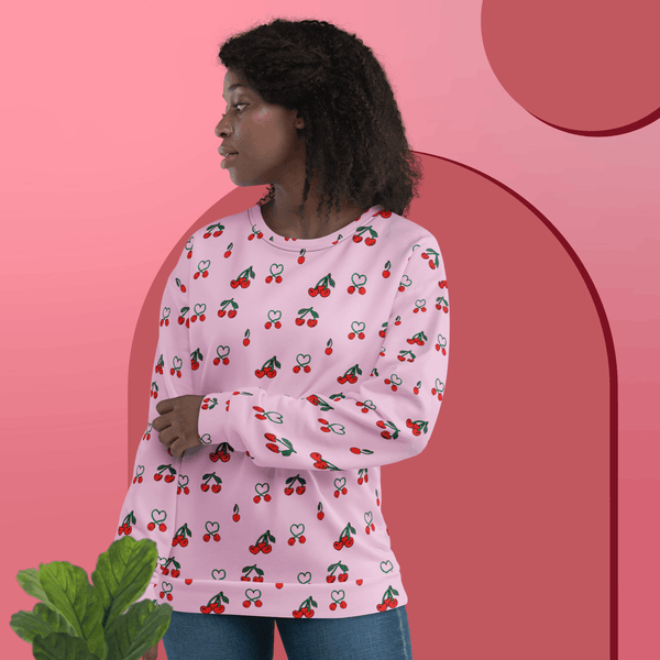 Black woman wearing Sweet Cherry Women's Recycled Polyester Sweatshirt, front view, sustainable fashion in vibrant pink with cherry pattern.