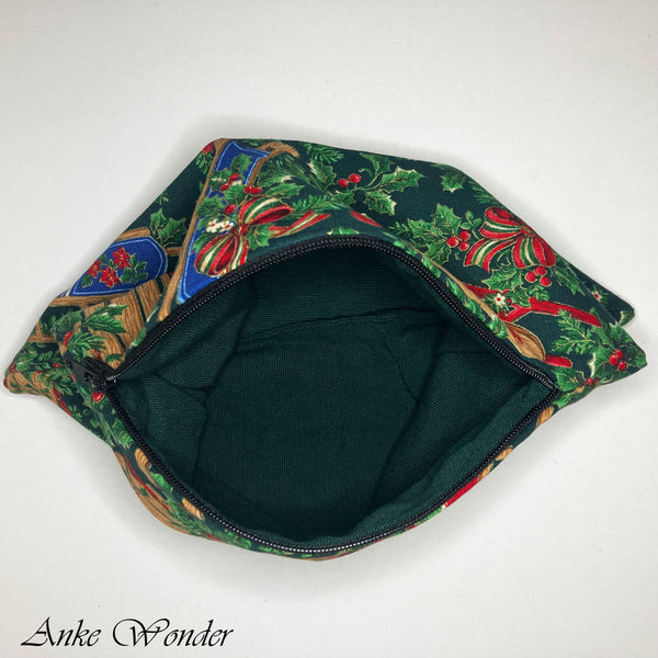 Interior view of Christmas zipper pouch with green lining, laid open on table.