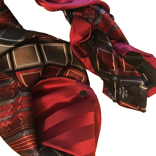 Close-up of the snap fasteners on a red and silver women's necktie, highlighting the easy-to-use closure and practical design for a busy lifestyle.