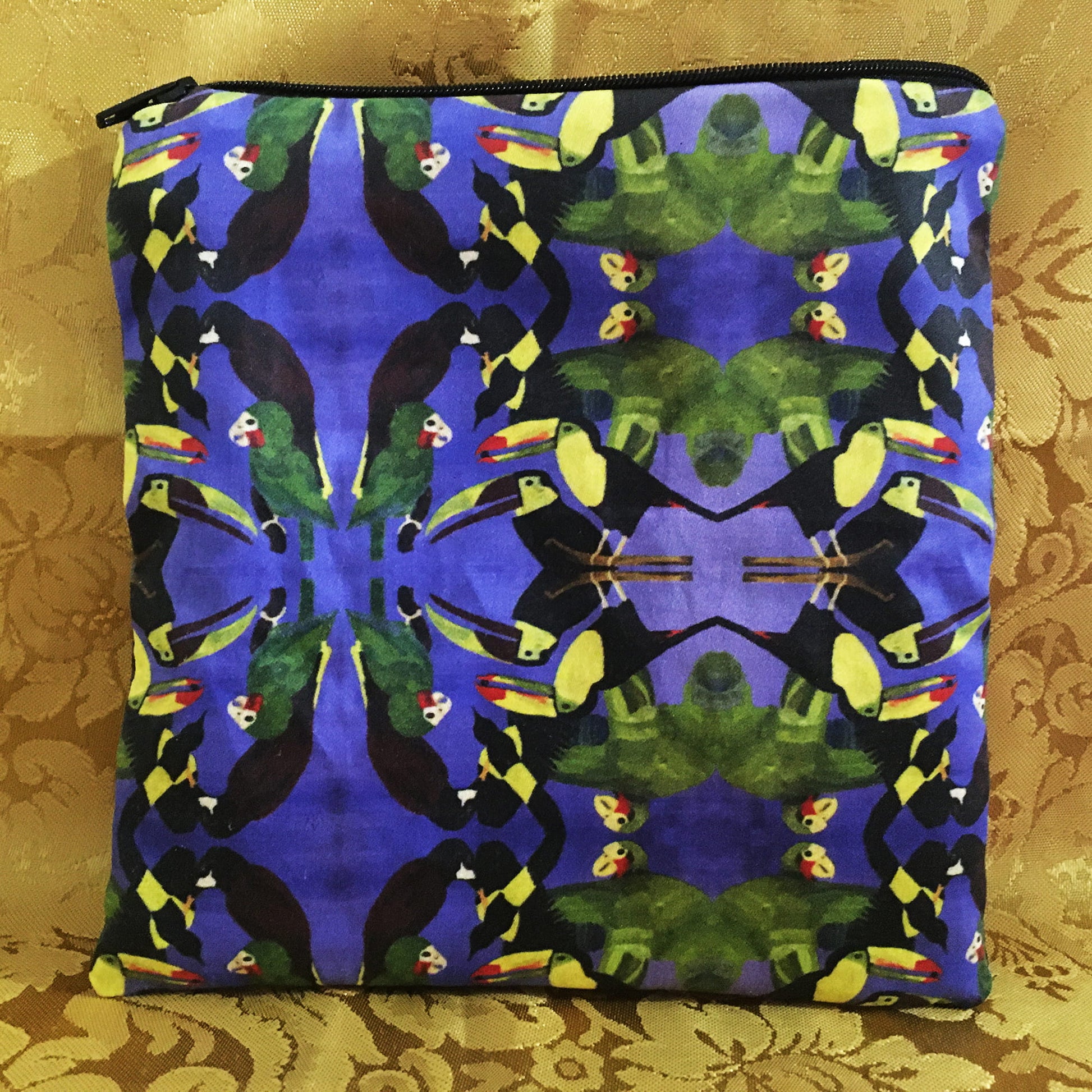 Pouch with toucan pattern on a blue background