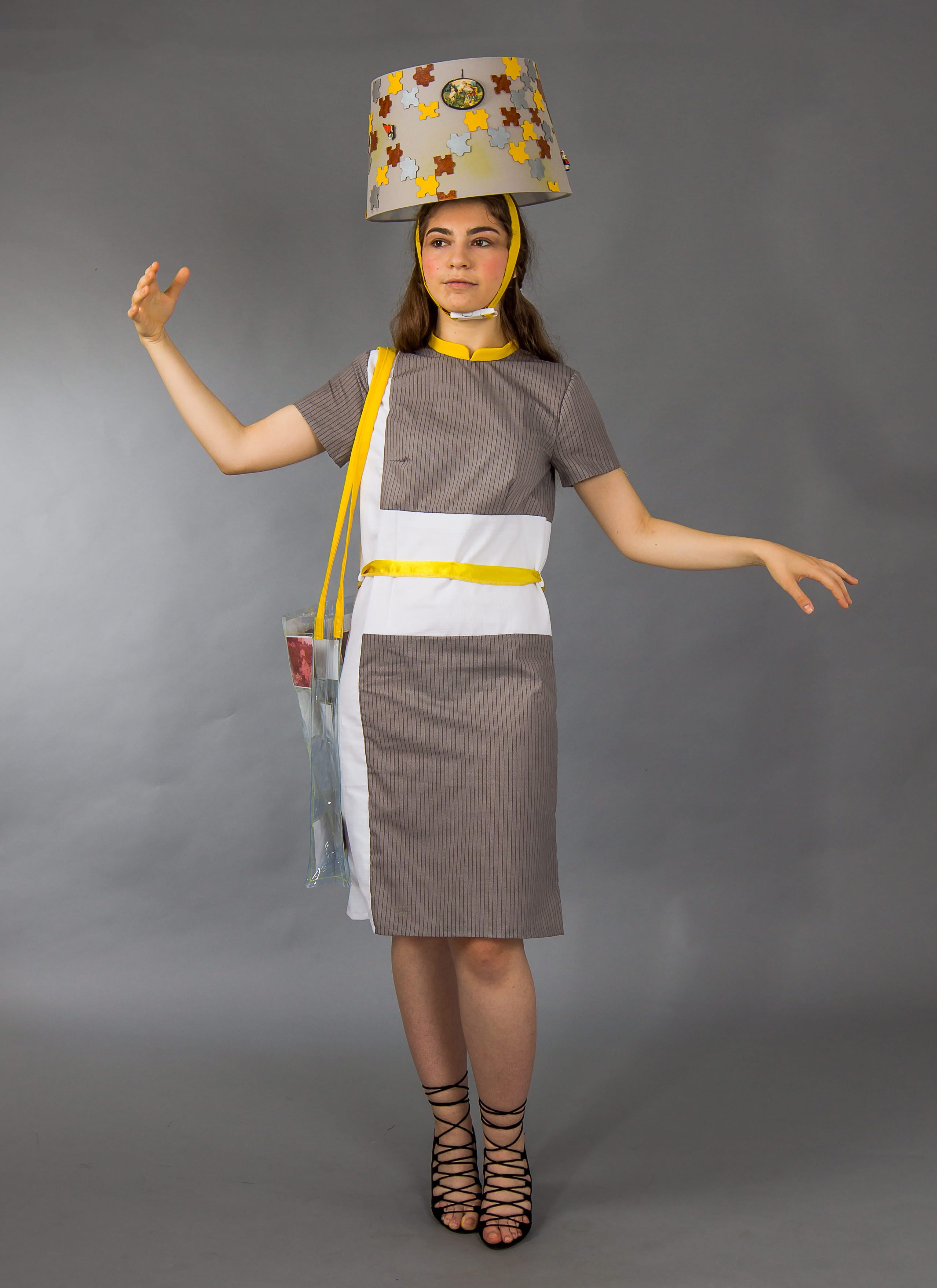 Person wearing a costume with a lampshade on their head against a gray background
