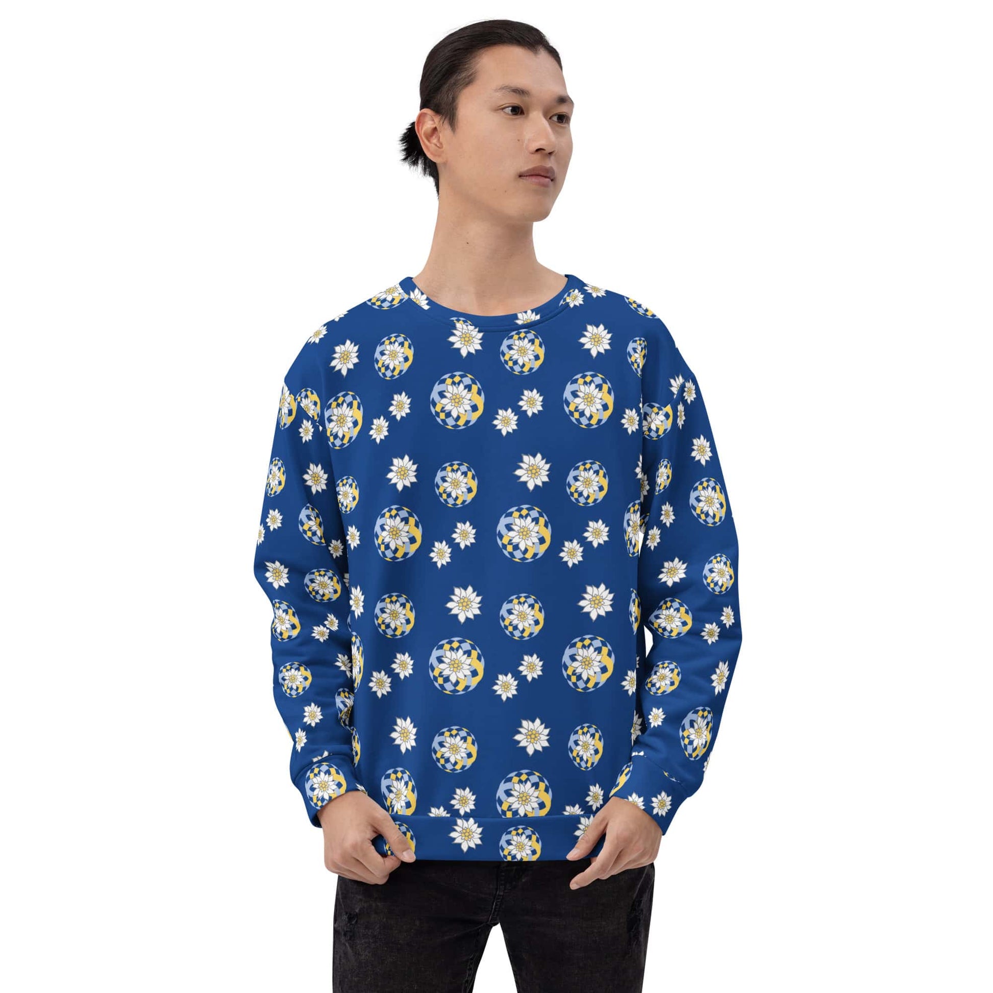 Man wearing a blue sweater with white and yellow floral Edelweiss pattern on a white background