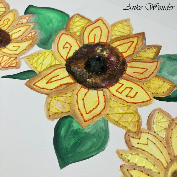 Detailed close-up of a hand-embroidered sunflower showcasing intricate stitching, layered yellow petals, and a rich brown center, designed by Anke Wonder.