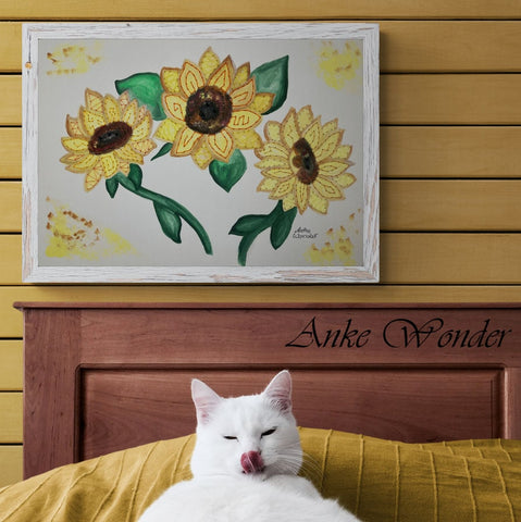 Hand-embroidered sunflower artwork hanging on a bedroom wall with a cat nearby, created by Anke Wonder.