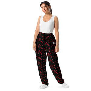 Front view of women's wide-leg joggers with vibrant red poppy flower print, featuring an elastic waistband and drawstring for a relaxed fit.