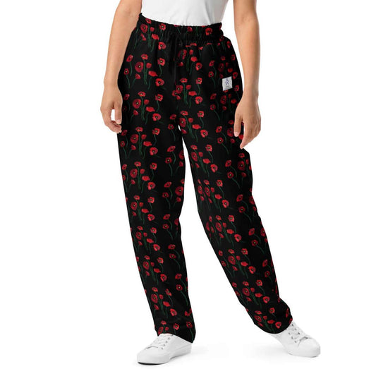Close-up front view of women's wide-leg joggers showcasing the detailed red poppy flower print, elastic waistband, and white drawstring.