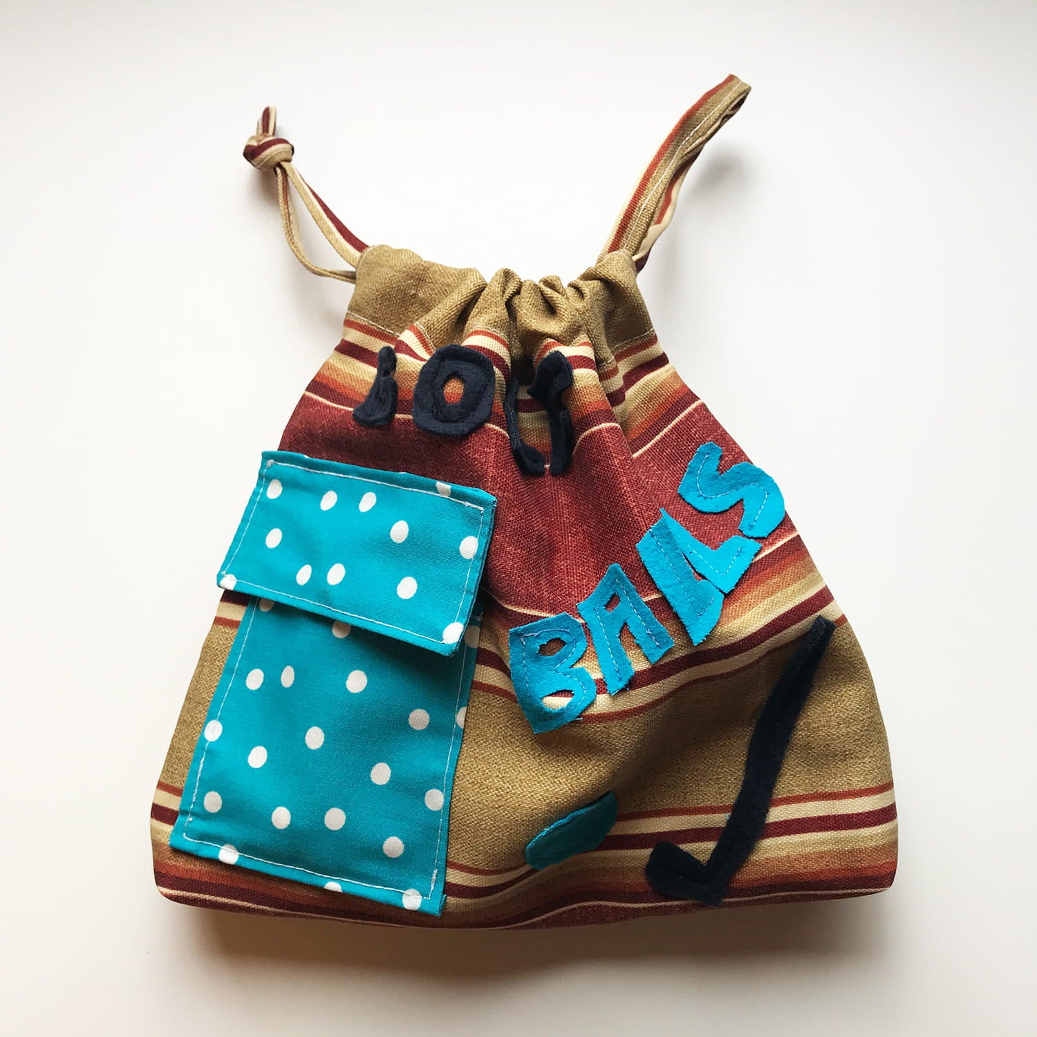 Drawstring bag with colorful design and text on a white background