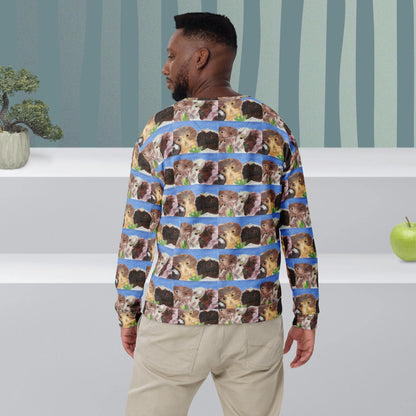 Man wearing a long-sleeve shirt with guinea pig pattern in a room with striped wallpaper.