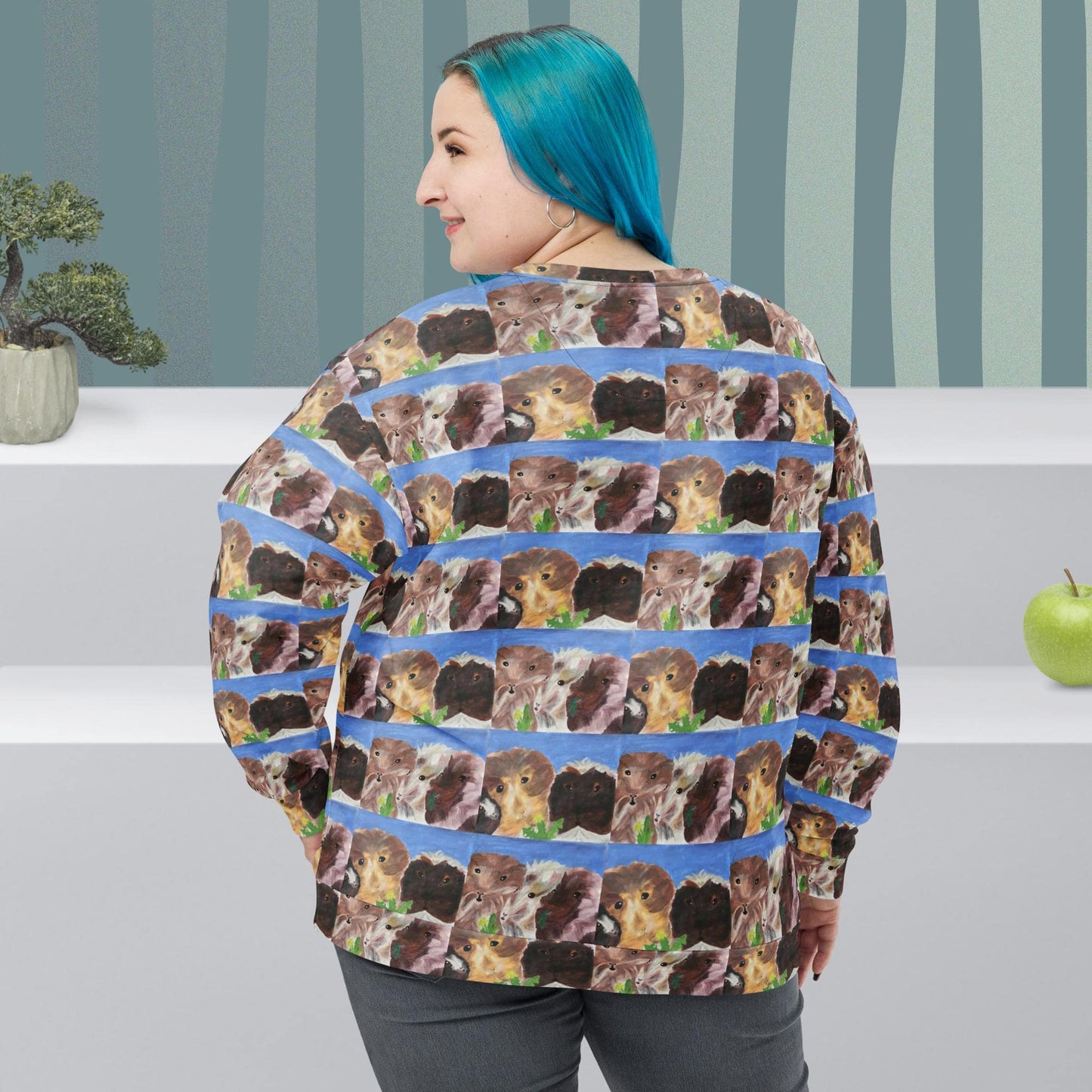 Back view of woman wearing a sweater with repeated pattern of  guinea pig faces on a striped background