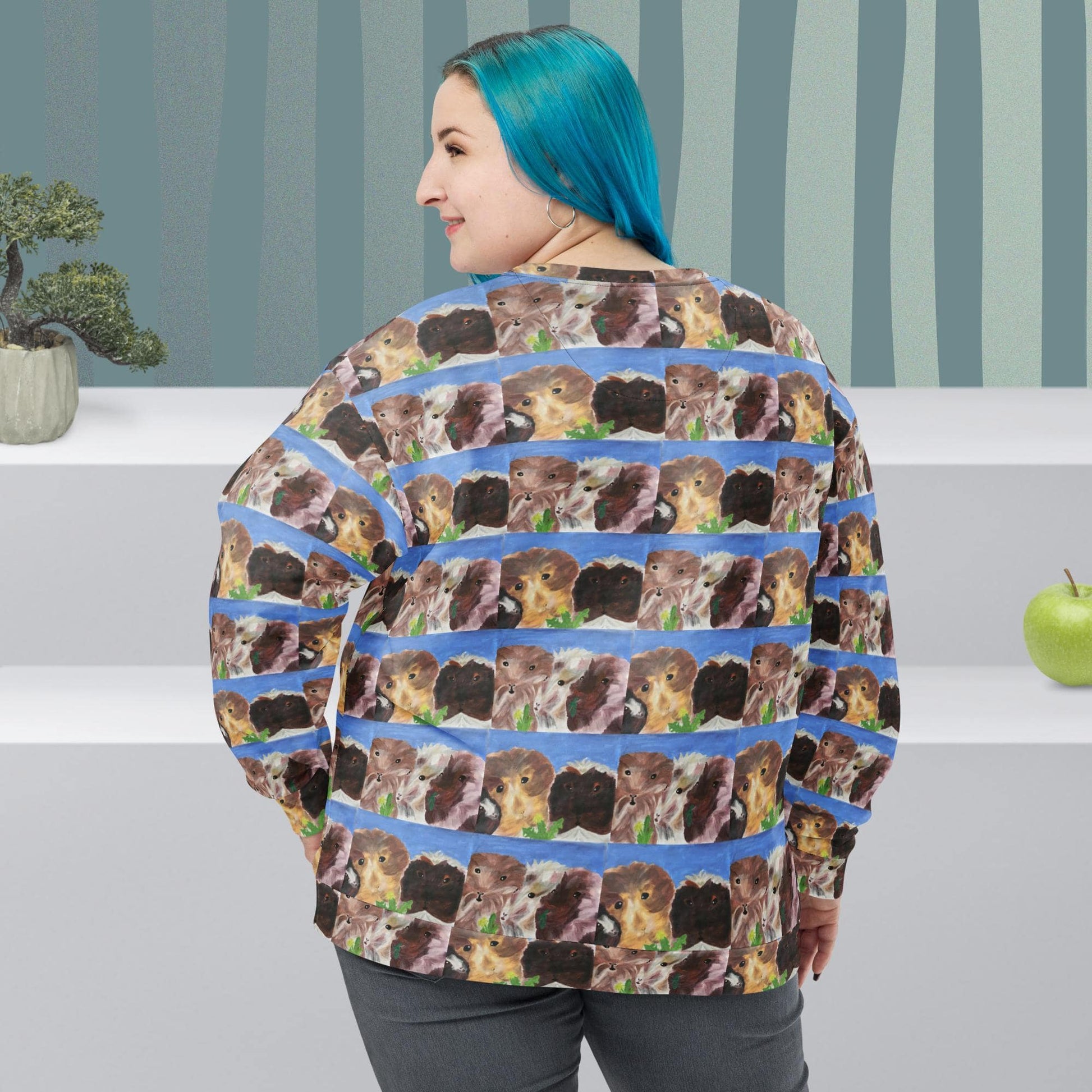 Back view of woman wearing a sweater with repeated pattern of  guinea pig faces on a striped background