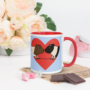 Right side view of blue ceramic mug featuring two guinea pigs in a red heart, with a vibrant red handle and rim.