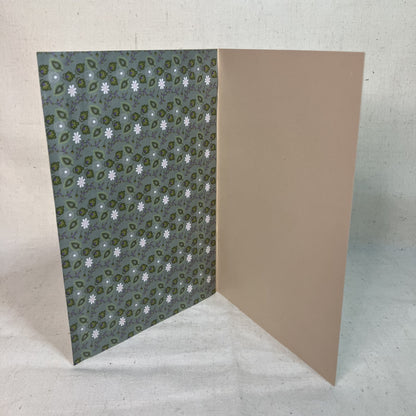 Green and white floral inside of a handmade greeting card by Anke Wonder.