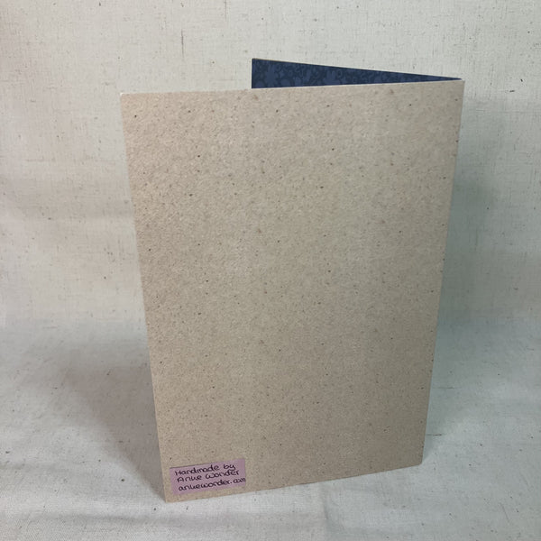 Beige Backside of a Happy Birthday Greeting Card with the Anke Wonder logo.