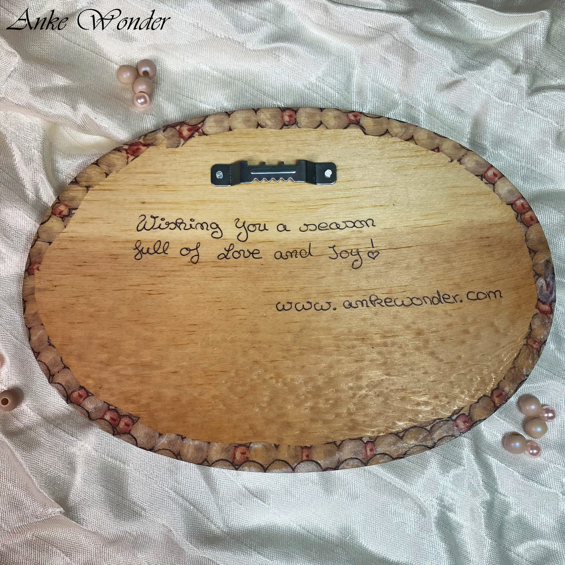 Backside of Christmas Handmade wooden wall decor with the words 'Wishing you a season full of Love and Joy' by Anke Wonder.